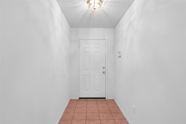 8300 Southern Prairie Dr, Fort Worth, TX 76123 - entryway featuring light tile patterned floors, a textured ceiling, and baseboards