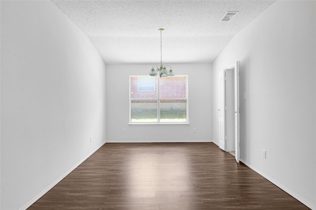 8300 Southern Prairie Dr, Fort Worth, TX 76123 - empty room featuring a chandelier, dark wood-type flooring, a textured ceiling, and baseboards