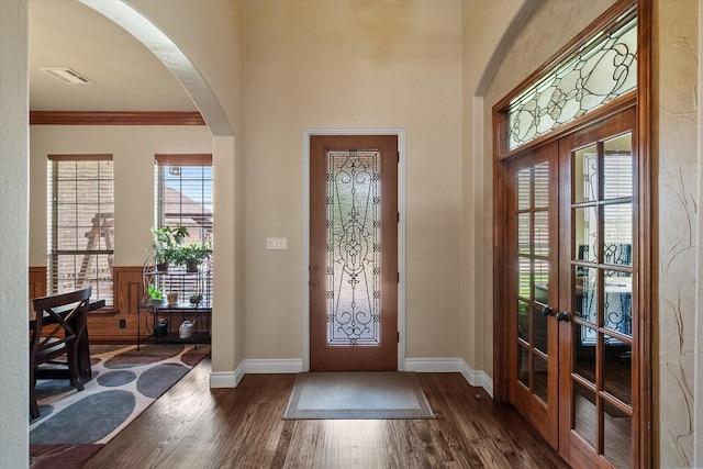 1205 Platte Dr, Mansfield, TX 76063 - foyer featuring dark wood-style flooring, arched walkways, french doors, baseboards, and ornamental molding