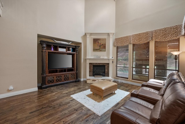 1205 Platte Dr, Mansfield, TX 76063 - living area with a towering ceiling, baseboards, a fireplace, and dark wood-type flooring