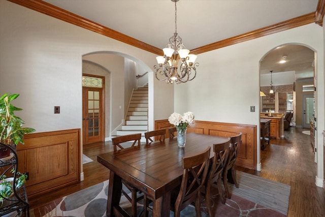 1205 Platte Dr, Mansfield, TX 76063 - dining area featuring arched walkways, dark wood-style floors, stairs, and ornamental molding