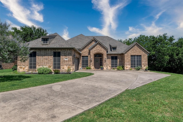 3400 Eisenhower Ave, Melissa, TX 75454 - french country inspired facade featuring brick siding, concrete driveway, an attached garage, and a front lawn