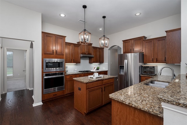 3400 Eisenhower Ave, Melissa, TX 75454 - kitchen featuring appliances with stainless steel finishes, a sink, a center island, light stone counters, and under cabinet range hood