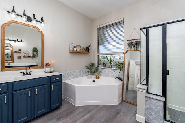 3400 Eisenhower Ave, Melissa, TX 75454 - bathroom featuring wood finished floors, a shower stall, vanity, and a garden tub