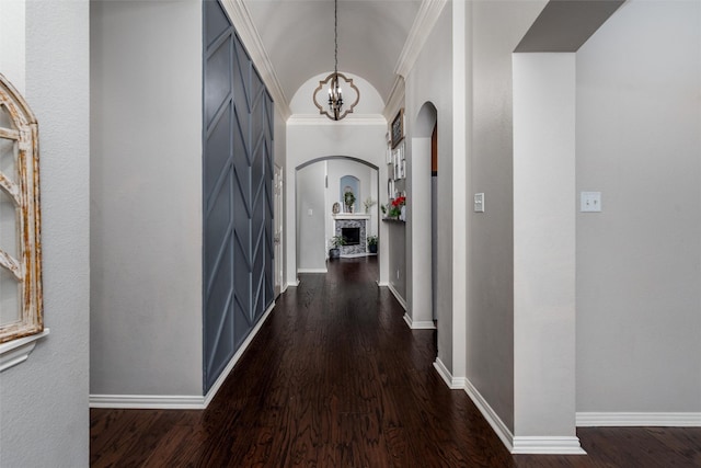 3400 Eisenhower Ave, Melissa, TX 75454 - corridor featuring arched walkways, a chandelier, dark wood finished floors, baseboards, and crown molding