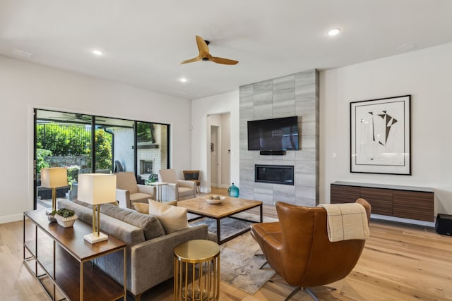 32 Katie Ln, Trophy Club, TX 76262 - living area with light wood-type flooring, ceiling fan, a tiled fireplace, recessed lighting, and baseboards