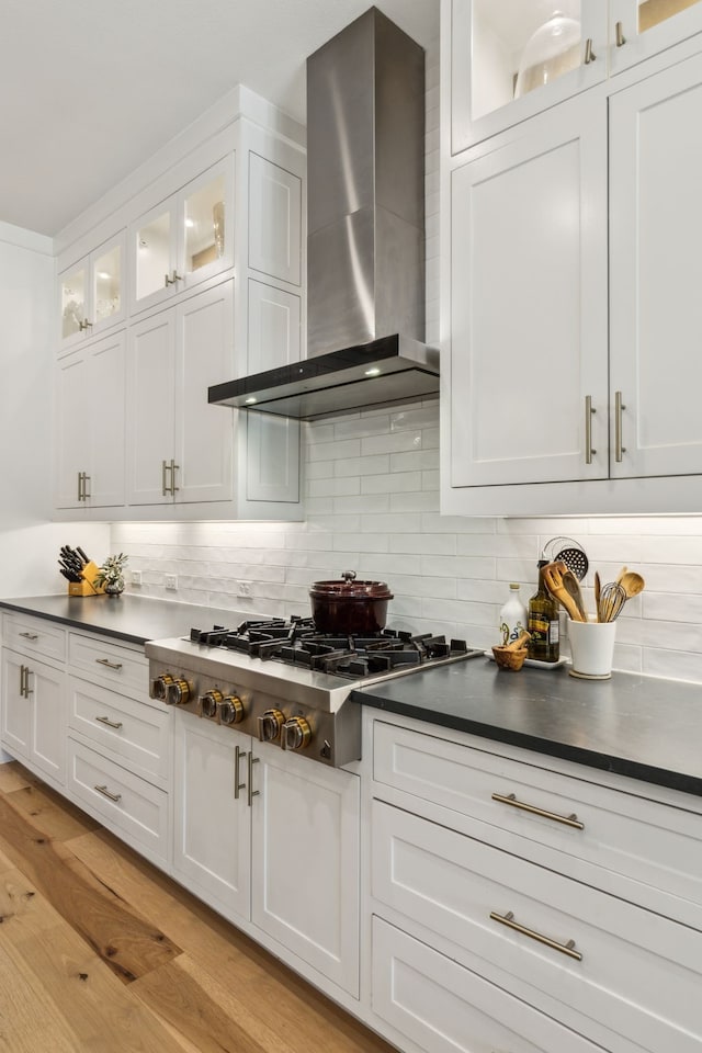 32 Katie Ln, Trophy Club, TX 76262 - kitchen featuring wall chimney exhaust hood, stainless steel gas cooktop, dark countertops, and white cabinets