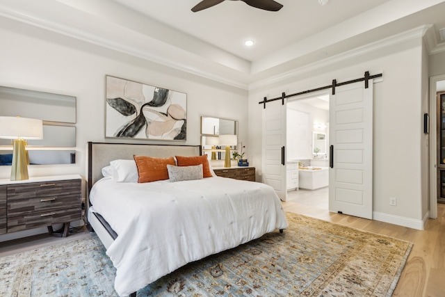 32 Katie Ln, Trophy Club, TX 76262 - bedroom featuring a barn door, wood finished floors, ensuite bath, recessed lighting, and baseboards