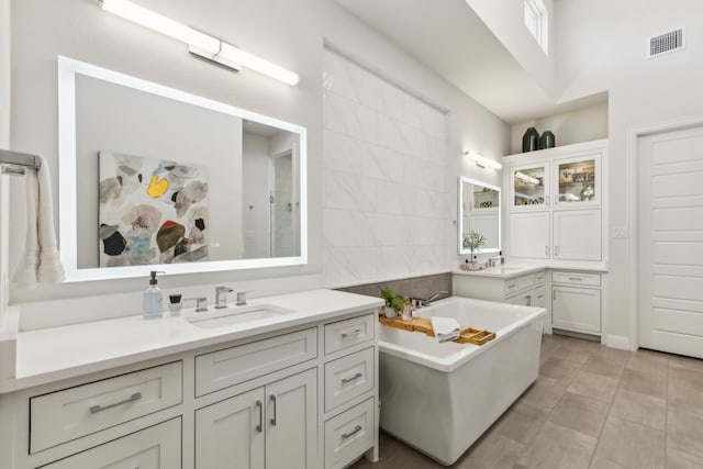 32 Katie Ln, Trophy Club, TX 76262 - bathroom featuring a freestanding tub, vanity, a high ceiling, and tile patterned floors