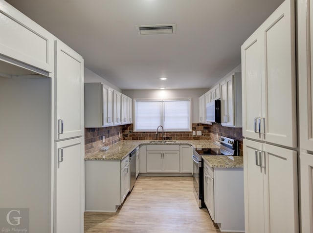732 Camilla Dr, Shreveport, LA 71104 - kitchen with stainless steel appliances, a sink, light stone countertops, decorative backsplash, and recessed lighting