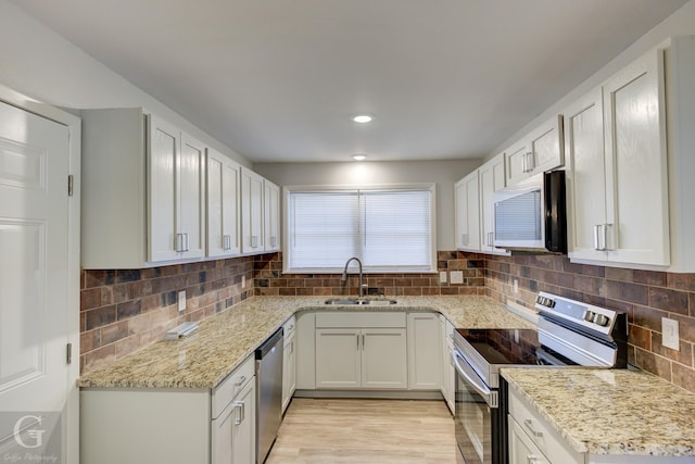 732 Camilla Dr, Shreveport, LA 71104 - kitchen with stainless steel appliances, a sink, tasteful backsplash, light stone counters, and recessed lighting