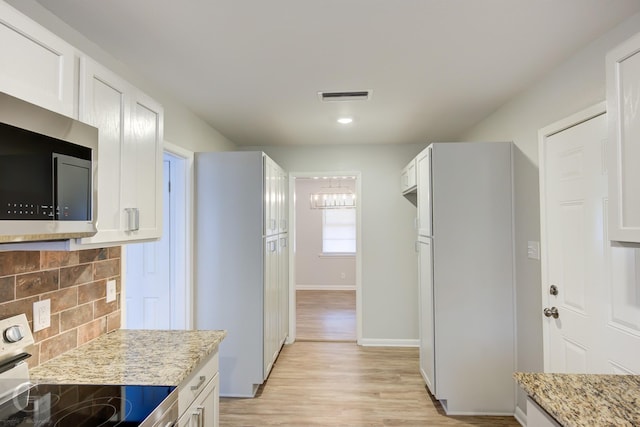 732 Camilla Dr, Shreveport, LA 71104 - kitchen with appliances with stainless steel finishes, light stone counters, backsplash, white cabinetry, and recessed lighting
