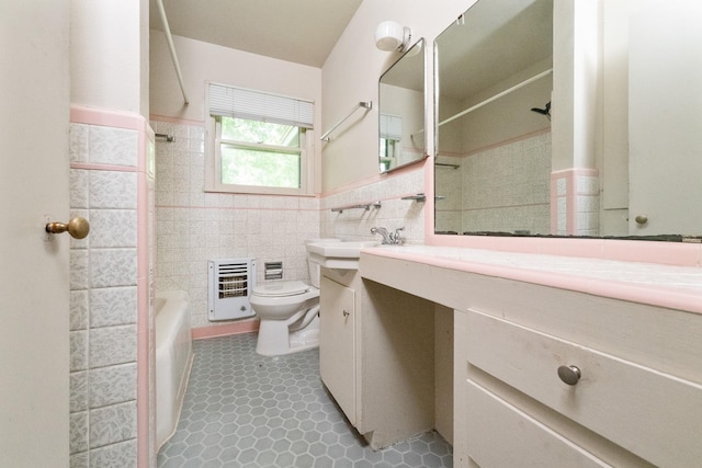 6908 Park Place Dr, Richland Hills, TX 76118 - full bathroom featuring toilet, heating unit, tile walls, vanity, and wainscoting