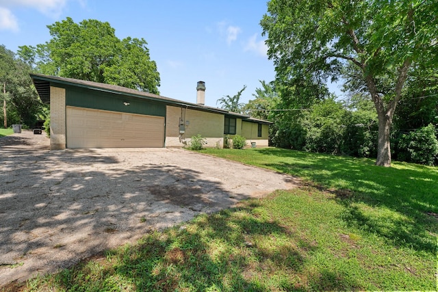 6908 Park Place Dr, Richland Hills, TX 76118 - view of front of home with brick siding, an attached garage, a chimney, a front yard, and asphalt driveway
