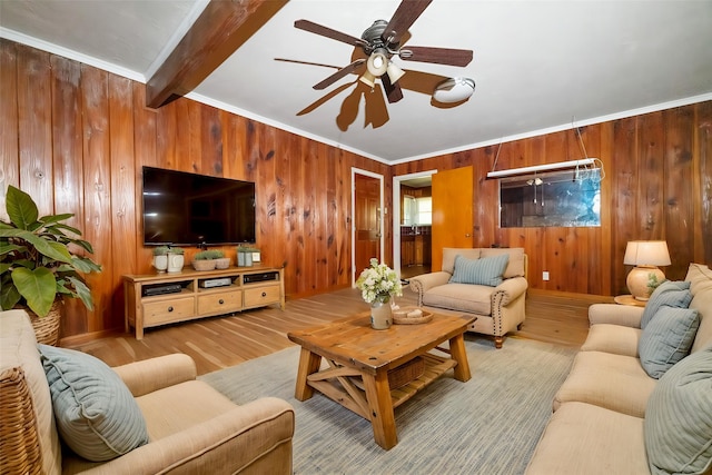 6908 Park Place Dr, Richland Hills, TX 76118 - living room featuring wood walls, wood finished floors, ceiling fan, beam ceiling, and crown molding