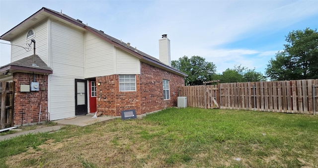 510 E Stone Cir, Wylie, TX 75098 - rear view of property featuring brick siding, a chimney, and a gate