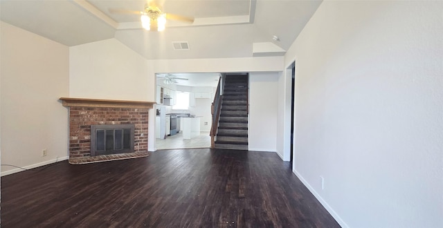 510 E Stone Cir, Wylie, TX 75098 - unfurnished living room featuring a ceiling fan, stairs, wood finished floors, a raised ceiling, and a fireplace