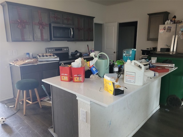 2160 Ocelot St, Crandall, TX 75114 - kitchen featuring stainless steel appliances, light countertops, and dark wood-type flooring