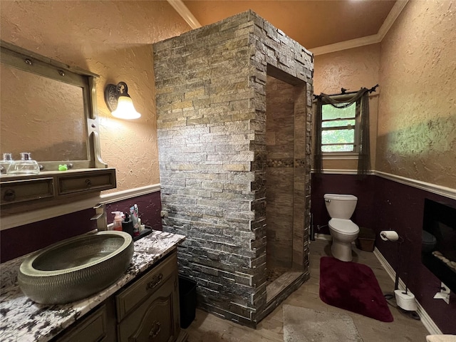 18637 Fm 17, Canton, TX 75103 - bathroom featuring toilet, a textured wall, a shower stall, crown molding, and a wainscoted wall