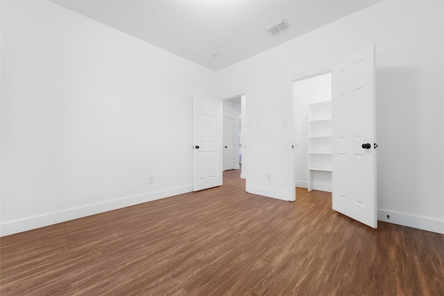3601 Aqua Springs Dr, Plano, TX 75025 - unfurnished bedroom with a spacious closet, baseboards, wood finished floors, and a closet