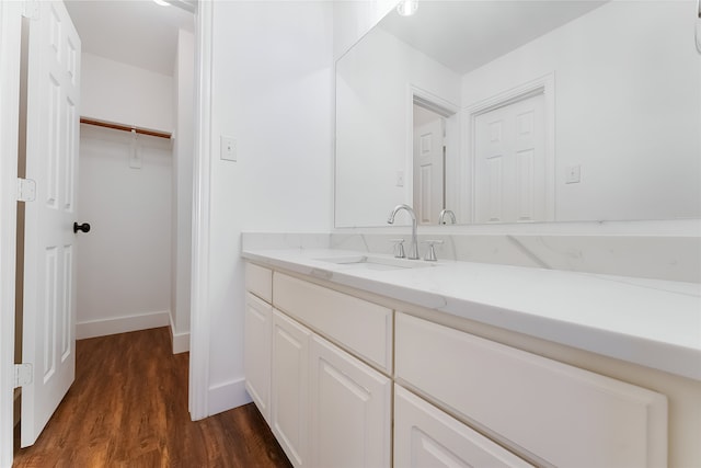 3601 Aqua Springs Dr, Plano, TX 75025 - bathroom featuring vanity, wood finished floors, and baseboards