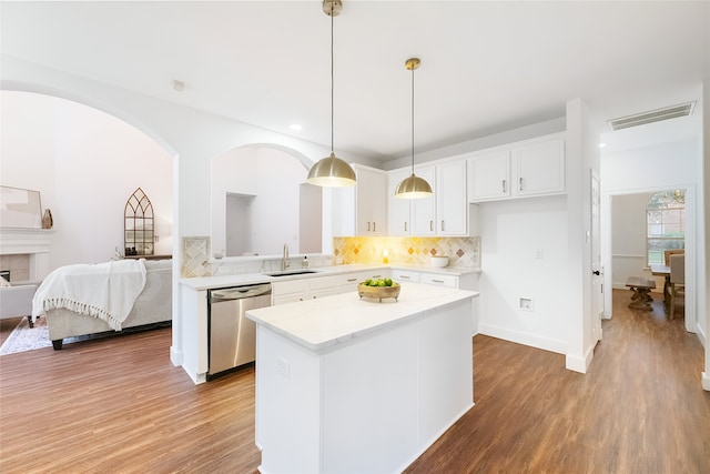 3601 Aqua Springs Dr, Plano, TX 75025 - kitchen featuring stainless steel dishwasher, a sink, light wood-style floors, a center island, and white cabinets