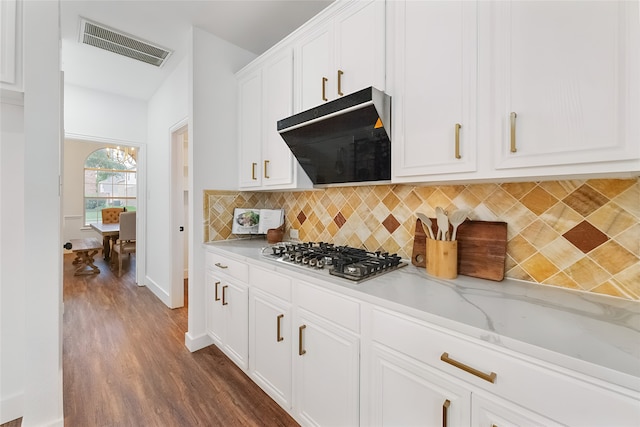 3601 Aqua Springs Dr, Plano, TX 75025 - kitchen featuring stainless steel gas stovetop, extractor fan, decorative backsplash, dark wood-type flooring, and white cabinets