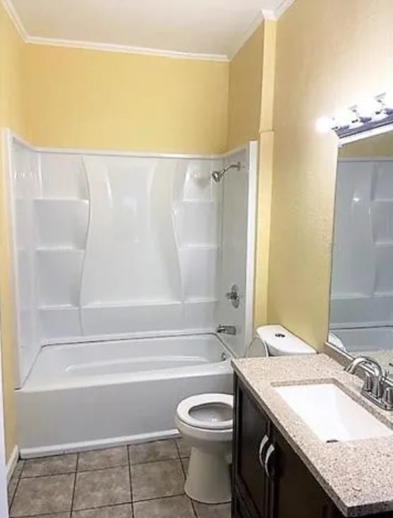 909 S Montgomery St, Sherman, TX 75090 - full bath with crown molding, toilet, vanity, bathtub / shower combination, and tile patterned floors