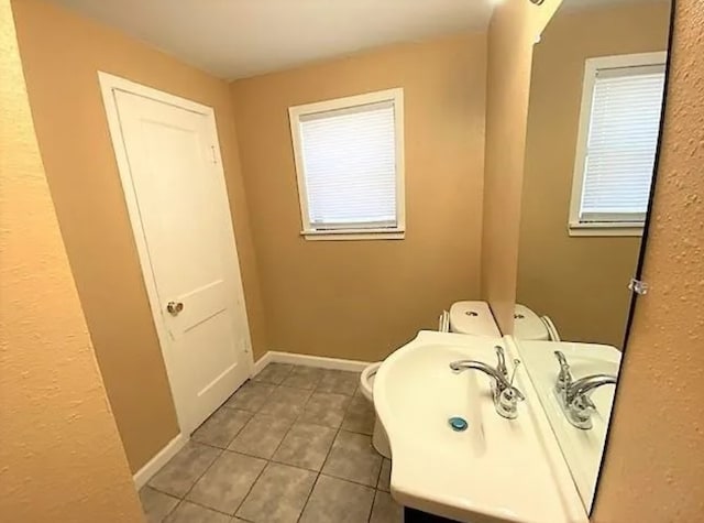 909 S Montgomery St, Sherman, TX 75090 - half bath featuring toilet, tile patterned floors, and vanity