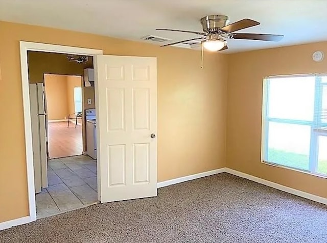 909 S Montgomery St, Sherman, TX 75090 - unfurnished room featuring a ceiling fan, light colored carpet, and baseboards