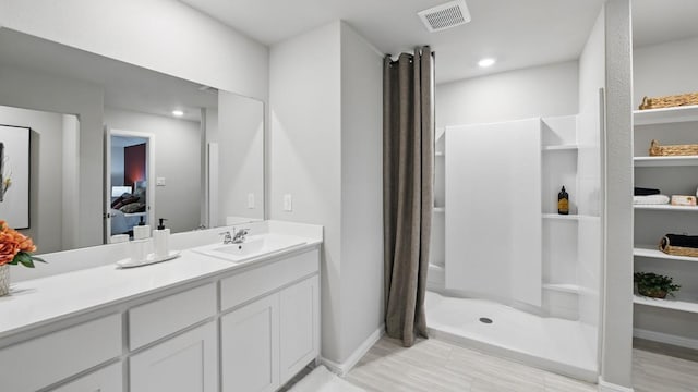 8417 Stout Dr, Fort Worth, TX 76131 - bathroom featuring vanity, connected bathroom, baseboards, and a shower