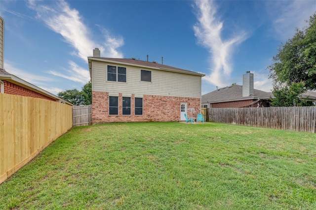 910 Glenbrook Dr, Grand Prairie, TX 75052 - back of house featuring brick siding and a chimney