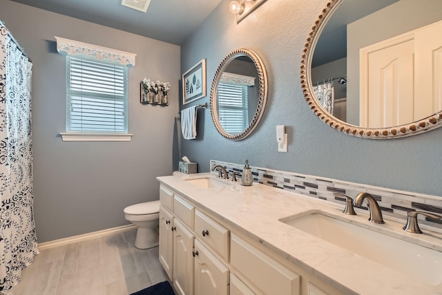 8633 Shadow Trace Dr, Fort Worth, TX 76244 - bathroom featuring double vanity, toilet, baseboards, backsplash, and a shower with curtain