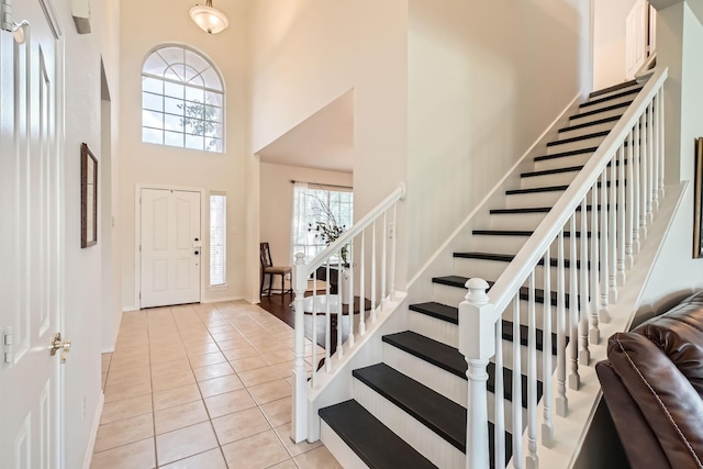 8633 Shadow Trace Dr, Fort Worth, TX 76244 - entrance foyer with a towering ceiling, stairs, light tile patterned floors, and baseboards