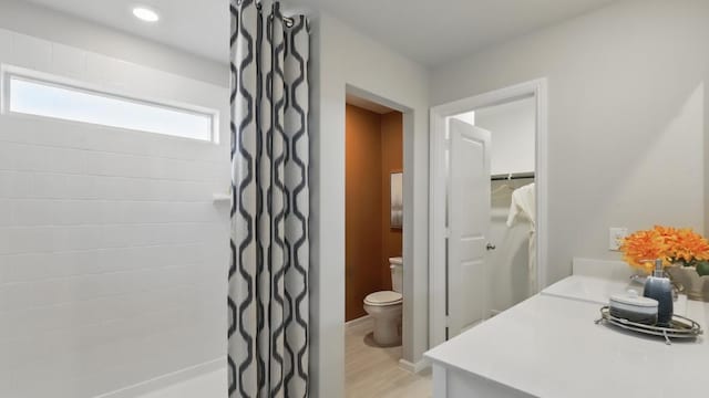 857 Cedarbrook, Fort Worth, TX 76131 - bathroom featuring toilet, a tile shower, vanity, and wood finished floors