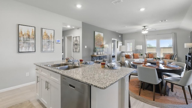 857 Cedarbrook, Fort Worth, TX 76131 - kitchen with stainless steel dishwasher, a sink, a kitchen island with sink, white cabinets, and baseboards