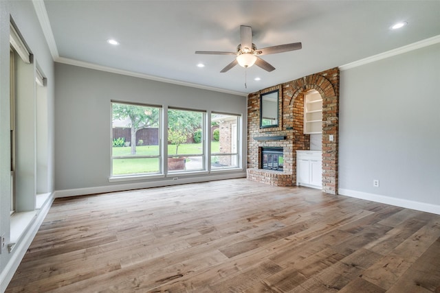 4113 Southwood E, Colleyville, TX 76034 - unfurnished living room with a brick fireplace, ceiling fan, wood finished floors, ornamental molding, and recessed lighting