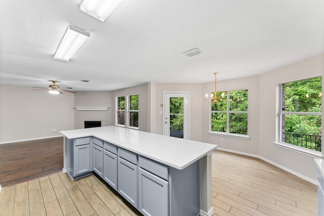 1817 Cedarbriar Dr, Mesquite, TX 75181 - kitchen featuring gray cabinetry, open floor plan, light wood finished floors, light countertops, and baseboards