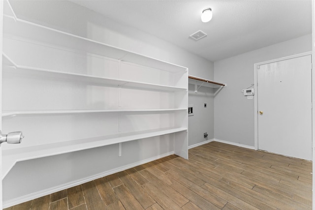 1817 Cedarbriar Dr, Mesquite, TX 75181 - laundry room featuring hookup for an electric dryer, wood finished floors, and baseboards