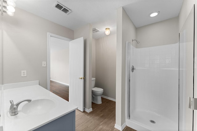 1817 Cedarbriar Dr, Mesquite, TX 75181 - bathroom featuring toilet, wood finished floors, a stall shower, and vanity