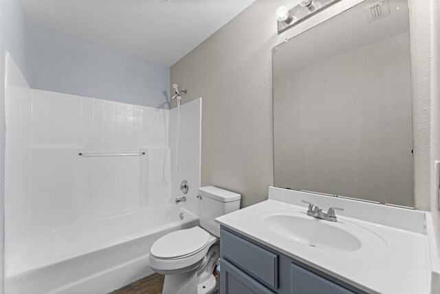 1817 Cedarbriar Dr, Mesquite, TX 75181 - bathroom featuring toilet, vanity, bathtub / shower combination, wood finished floors, and a textured wall