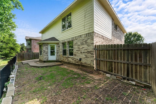 1817 Cedarbriar Dr, Mesquite, TX 75181 - back of house featuring brick siding, a patio area, and a fenced backyard