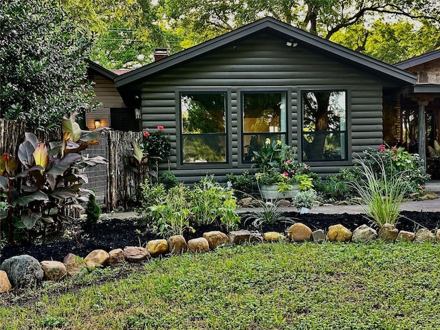 4000 Pecan Ln, Benbrook, TX 76116 - view of front of house with a chimney, log siding, and a front yard