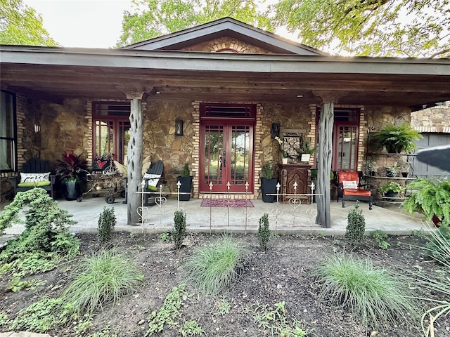 4000 Pecan Ln, Benbrook, TX 76116 - property entrance with french doors, stone siding, and a patio area