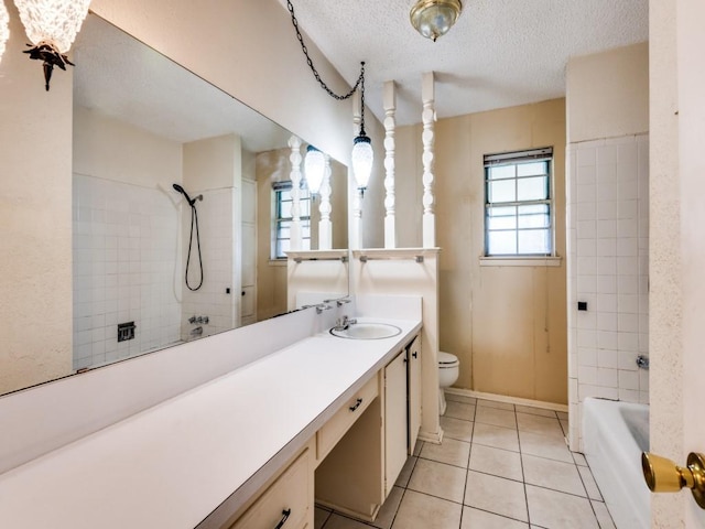 809 S Ridgeway Dr, Cleburne, TX 76033 - bathroom with toilet, vanity, a textured ceiling, tile patterned floors, and bathtub / shower combination