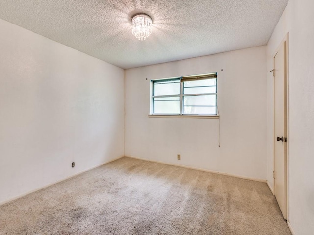 809 S Ridgeway Dr, Cleburne, TX 76033 - carpeted spare room with a textured ceiling and a chandelier