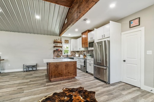 9759 Fm 638, Dawson, TX 76639 - kitchen with stainless steel appliances, open shelves, light wood-type flooring, backsplash, and beamed ceiling