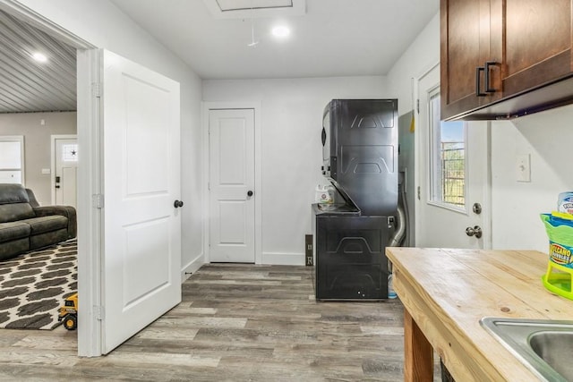 9759 Fm 638, Dawson, TX 76639 - washroom featuring stacked washer / drying machine, attic access, light wood-style flooring, cabinet space, and recessed lighting