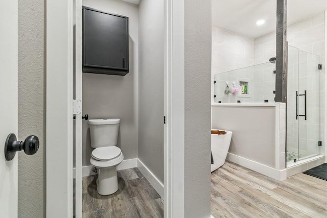 9759 Fm 638, Dawson, TX 76639 - bathroom with wood finished floors, a stall shower, toilet, and baseboards