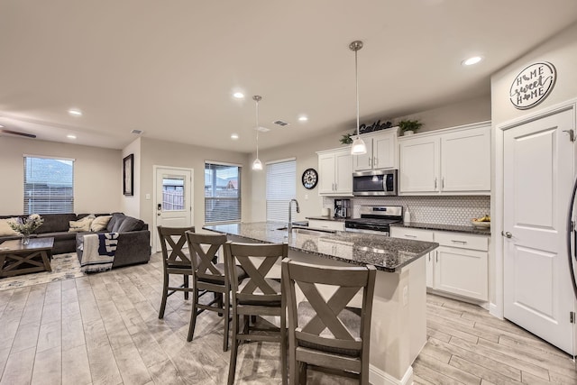 14613 Bootes Dr, Haslet, TX 76052 - kitchen with stainless steel appliances, light wood-style floors, a sink, healthy amount of natural light, and recessed lighting